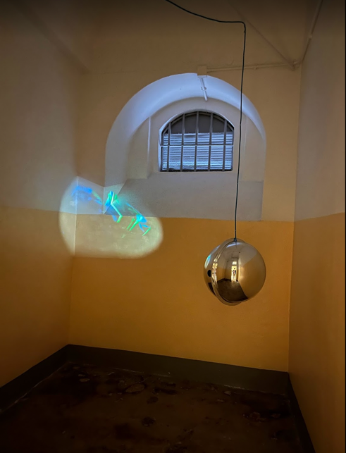 A light fixture from a ceiling Description automatically generated with medium confidence